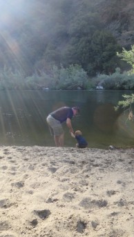 Alex looking for rocks to toss into the river.
